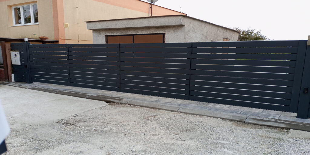 we designed, manufactured, and installed an oversized double-leaf folding gate with full automation, a pedestrian gate with stainless steel hardware and an integrated mailbox, as well as fencing for the front part of the property